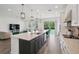 Bright, open kitchen featuring a large island, quartz countertops, pendant lighting, and stainless steel appliances at 9508 Pyrenees Pl, Seffner, FL 33584