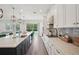 Modern kitchen with stainless steel appliances, a large island, and plenty of counter space at 9508 Pyrenees Pl, Seffner, FL 33584