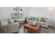 Bright living room with a large window, comfortable seating, and modern accents at 9508 Pyrenees Pl, Seffner, FL 33584