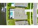 Overhead aerial view of the property with a pool, screened in patio, dock, and luscious landscaping at 978 Signet Dr, Apollo Beach, FL 33572