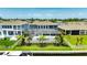 Aerial view of the backyard with a pool, screened in patio, luscious landscaping and a waterway at 978 Signet Dr, Apollo Beach, FL 33572