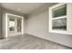 Enclosed balcony featuring gray tiled flooring, neutral paint, window and glass door access to interior at 978 Signet Dr, Apollo Beach, FL 33572