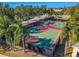 The community has a basketball court with multiple hoops surrounded by mature trees at 978 Signet Dr, Apollo Beach, FL 33572