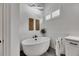 A modern bathroom featuring a soaking tub and a window with plantation shutters at 978 Signet Dr, Apollo Beach, FL 33572