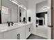 Modern bathroom with double sinks, sleek black fixtures, and access to a monochrome bedroom at 978 Signet Dr, Apollo Beach, FL 33572