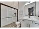 Modern bathroom with glass-enclosed shower, sleek black hardware, and white vanity at 978 Signet Dr, Apollo Beach, FL 33572
