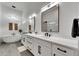 The bright bathroom has double sinks, modern fixtures, and a stand-alone tub at 978 Signet Dr, Apollo Beach, FL 33572
