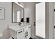 Bright bathroom featuring a white vanity with black hardware and a large framed mirror at 978 Signet Dr, Apollo Beach, FL 33572