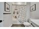 Bathroom with white fixtures, artwork, gray tile and shower with fun soccer ball shower curtain at 978 Signet Dr, Apollo Beach, FL 33572