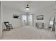 Bedroom with natural light, carpet, rocking chair and modern desk set is a relaxing, neutral space at 978 Signet Dr, Apollo Beach, FL 33572