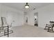 Well-lit bedroom featuring a light gray carpet, a storage closet, and a rocking chair at 978 Signet Dr, Apollo Beach, FL 33572