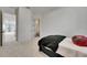 Bedroom with neutral walls and carpet features a twin bed and access to bathroom and living area at 978 Signet Dr, Apollo Beach, FL 33572
