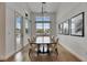 Elegant dining room with ample natural light, hardwood floors, and modern art pieces at 978 Signet Dr, Apollo Beach, FL 33572