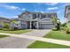 Beautiful home features a manicured lawn and garden, complemented by a spacious driveway and 2-car garage at 978 Signet Dr, Apollo Beach, FL 33572