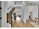 Bright, open foyer showcasing a modern staircase, hardwood floors, and a glimpse of the living area at 978 Signet Dr, Apollo Beach, FL 33572