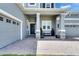 Inviting front porch with stone-accented columns, seating, and a well-maintained entrance at 978 Signet Dr, Apollo Beach, FL 33572