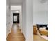 Hallway featuring hardwood floors and leads to the living room, creating a sense of spaciousness at 978 Signet Dr, Apollo Beach, FL 33572