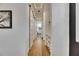 A hallway features hardwood floors, and sliding doors to the bathroom at 978 Signet Dr, Apollo Beach, FL 33572