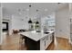 Open concept kitchen featuring a large island, hardwood floors, and seamless flow into living spaces at 978 Signet Dr, Apollo Beach, FL 33572