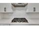 Close-up showcasing stainless steel gas range on quartz countertop with stylish tile backsplash and cabinetry at 978 Signet Dr, Apollo Beach, FL 33572