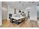 Modern kitchen with large island, quartz countertops, stainless steel appliances, and hardwood flooring at 978 Signet Dr, Apollo Beach, FL 33572