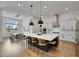 Bright, modern kitchen features a large island with seating, stainless steel appliances, and adjacent dining area at 978 Signet Dr, Apollo Beach, FL 33572