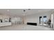 Spacious living room with recessed lighting, neutral carpet, bar, access to balcony and modern chandelier at 978 Signet Dr, Apollo Beach, FL 33572