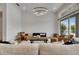 Spacious living room with two leather chairs, sliding glass doors, and modern light fixture at 978 Signet Dr, Apollo Beach, FL 33572