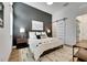 Stylish main bedroom with dark accent wall, sliding barn door, and elegant decor at 978 Signet Dr, Apollo Beach, FL 33572
