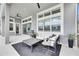 Inviting outdoor patio with stylish seating, ceiling fans, and lush plants, perfect for relaxation at 978 Signet Dr, Apollo Beach, FL 33572