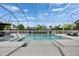 A stunning pool with clear water and a screened enclosure, complete with built-in lounge seating at 978 Signet Dr, Apollo Beach, FL 33572