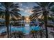 Enjoy evenings at the community pool with a slide, palm trees, and relaxing sunset view at 978 Signet Dr, Apollo Beach, FL 33572