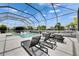 A sparkling pool featuring lounge chairs underneath a screened enclosure, perfect for relaxation and enjoyment at 978 Signet Dr, Apollo Beach, FL 33572
