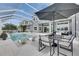Outdoor pool area with lounge chairs, dining set, and screened enclosure for perfect relaxation and entertaining at 978 Signet Dr, Apollo Beach, FL 33572