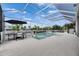 Outdoor pool and spa with dining and lounge areas covered by a screened enclosure, offering privacy and comfort at 978 Signet Dr, Apollo Beach, FL 33572