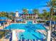 A stunning community pool features a water slide, palm trees and plenty of seating at 978 Signet Dr, Apollo Beach, FL 33572