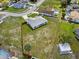 Aerial of single-Gathering home featuring a large yard, new wooden fence, and neighborhood setting at 10115 Briar Cir, Hudson, FL 34667