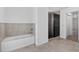 Modern bathroom with separate bathtub and walk-in shower with sliding glass door at 10115 Briar Cir, Hudson, FL 34667