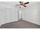 Cozy bedroom featuring neutral carpet, ceiling fan, and closet for ample storage at 10115 Briar Cir, Hudson, FL 34667
