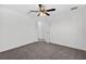 Bedroom featuring ceiling fan, plush carpet, and an open door leading to other rooms at 10115 Briar Cir, Hudson, FL 34667