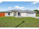 Inviting single-Gathering home boasts a well-manicured lawn, modern design, and attached two-car garage at 10115 Briar Cir, Hudson, FL 34667