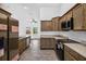 View of the kitchen with stainless steel appliances and light wood cabinets at 10115 Briar Cir, Hudson, FL 34667