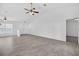 Living room with tile flooring, ceiling fans, and natural light at 10115 Briar Cir, Hudson, FL 34667