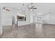 Spacious living room with tile flooring and ceiling fans with a view to the kitchen at 10115 Briar Cir, Hudson, FL 34667