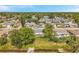 Exterior of home in a lovely neighborhood with mature trees and landscaping, providing a serene and welcoming atmosphere at 10125 Cherry Creek Ln, Port Richey, FL 34668