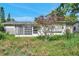 Residential building overgrown with weeds and showing visible signs of neglect at 10125 Cherry Creek Ln, Port Richey, FL 34668