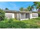 Residential building overgrown with weeds and showing visible signs of neglect at 10125 Cherry Creek Ln, Port Richey, FL 34668