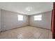 This bedroom has tile flooring and natural light from two windows at 10125 Cherry Creek Ln, Port Richey, FL 34668