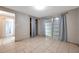 Bedroom featuring tile floors, natural light, and convenient closet access at 10125 Cherry Creek Ln, Port Richey, FL 34668