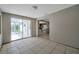 Bright dining room featuring tile floors, sliding glass doors to Florida room, and access to the kitchen at 10125 Cherry Creek Ln, Port Richey, FL 34668